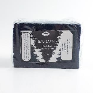 Bar of Pitch-dark charcoal soap against white background